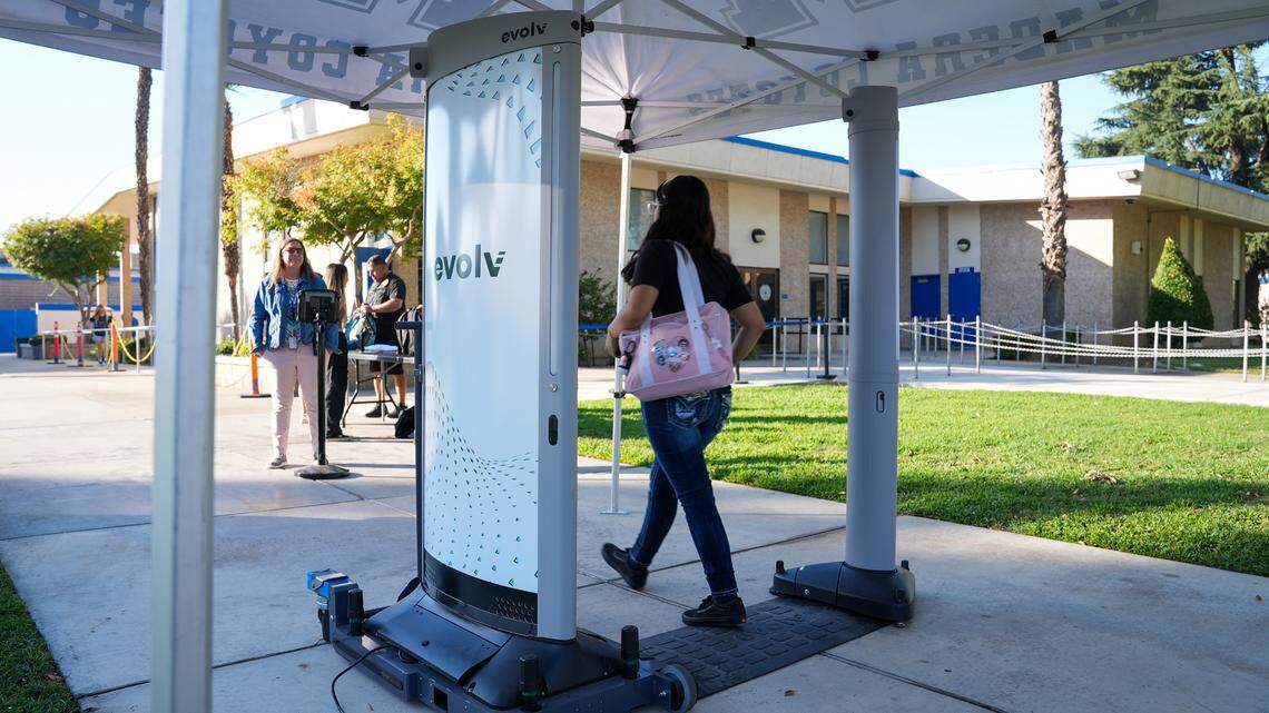 A Madera High School student walks past an Evolv Express weapons detector at the school’s entrance without having to remove personal belongings. The system is designed to locate potential weapons concealed within belongings, such as pockets or a backpack.