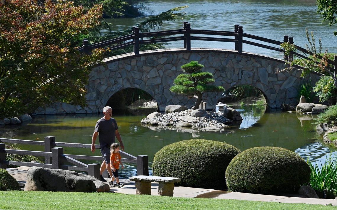 Allen Miller walks along the Koi Pond with his grandson Leonidas Bell, 3, nside Fresno’s Shinzen Friendship Garden in Woodward Park Thursday, Sept 5, 2024 in Fresno.
