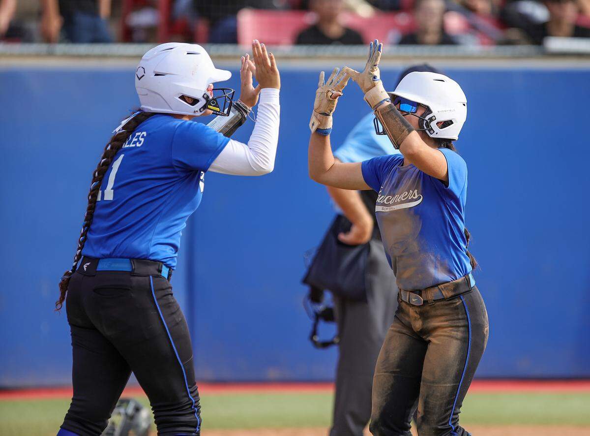Avenal teammates high-five during a 11-0 victory over Minarets in the Central Section Division VI championship.