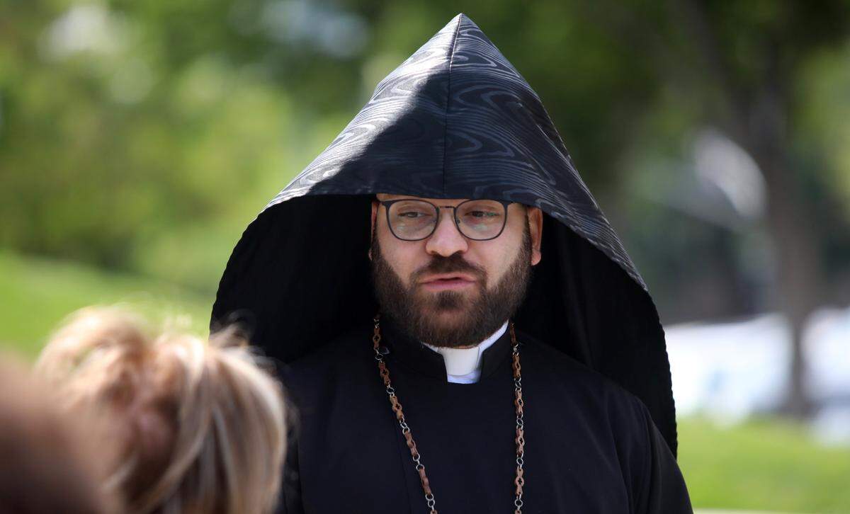 Rev. Fr. Ashod Khachadourian of Fresno’s Holy Trinity Armenian Apostolic Church awaits the start of the annual Armenian genocide commemoration and flag-raising ceremony at Fresno City Hall on April 24, 2025.