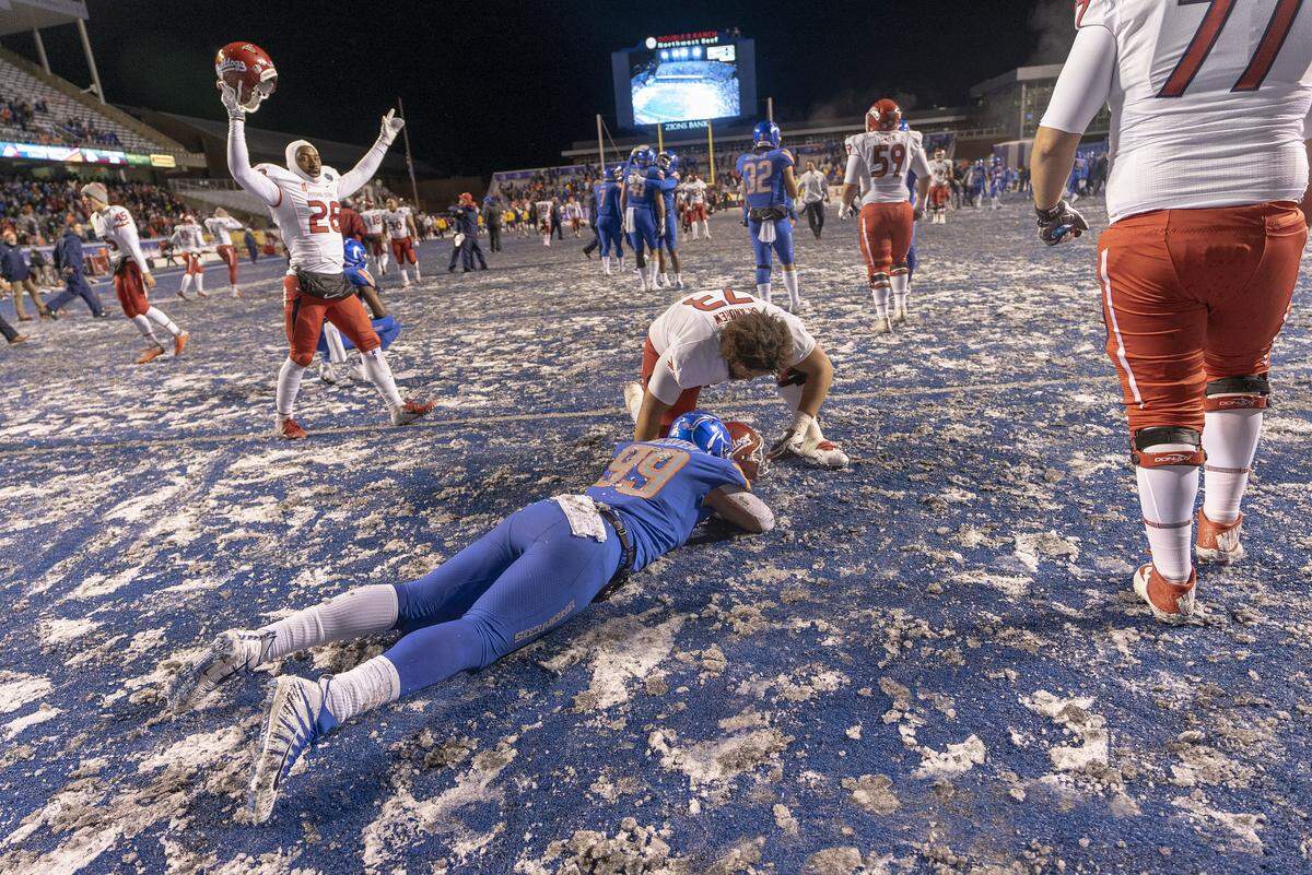 Fresno State offensive lineman Micah St. Andrew (73) comforts Boise State linebacker Curtis Weaver (99) after the end of the Mountain West Championship game at Albertsons Stadium. Fresno State defeated Boise State 19-16 in overtime. Saturday Dec. 1, 2018.