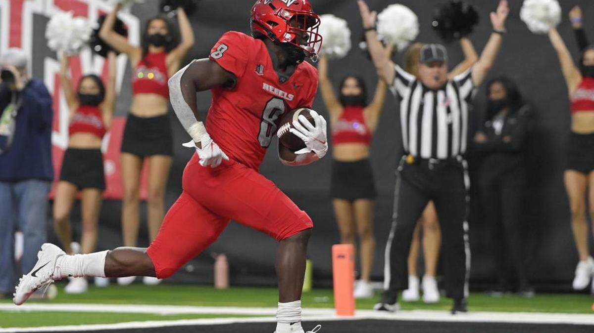 Former UNLV running back Charles Williams runs into the end zone for a touchdown against Hawaii during the second half of an NCAA college football game Saturday, Nov. 13, 2021, in Las Vegas.