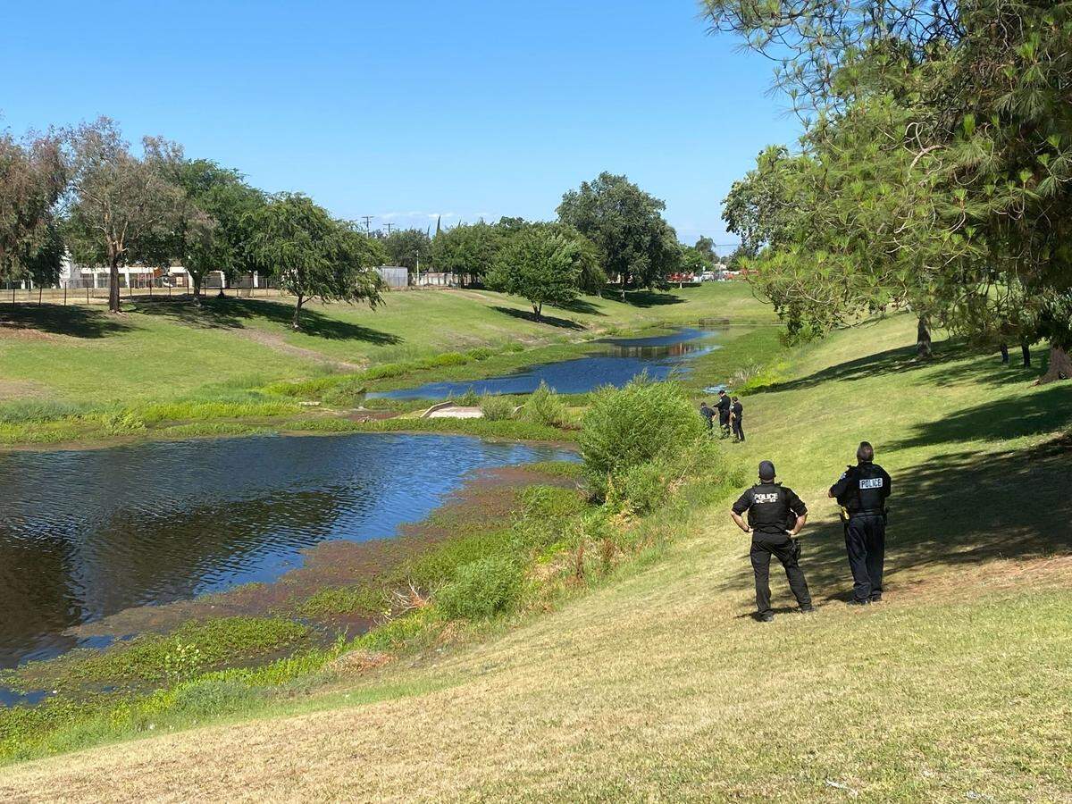 Rescue personnel respond to a reported drowning at a ponding basin near Winery and Ashlan avenues in Fresno, California, on Monday, June 13, 2022.