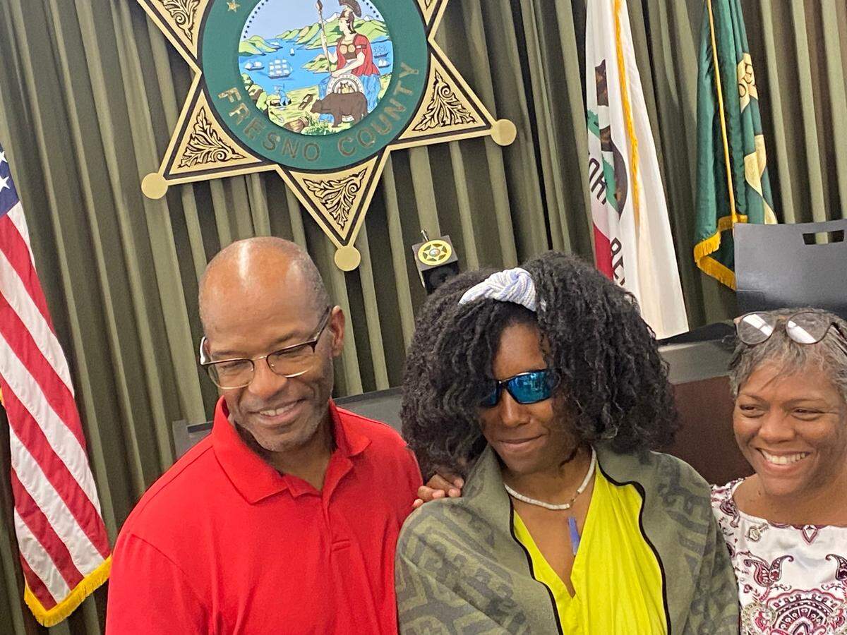 Tiffany Slaton, middle, with her dad, Bobby, and mom, Fredrina during a news conference in Fresno, California on Friday, May 16, 2025.
