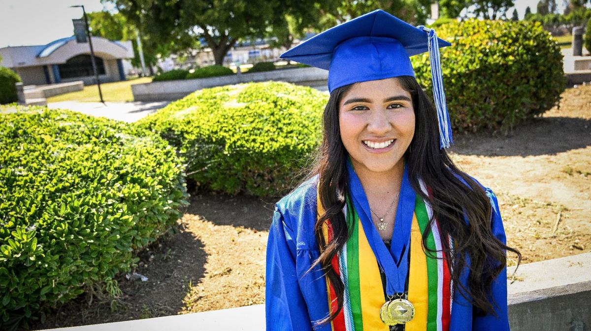 Anasol Martínez-García, a Farmersville High School Horatio Alger scholarship recipient, is photographed in her graduation cap and gown at the school on Tuesday, May 21, 2024.