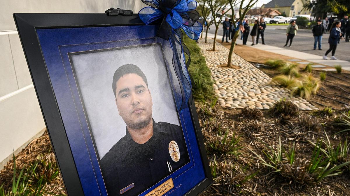 A portrait of fallen Selma Police Officer Gonzalo Carrasco Jr. who was killed in the line of duty one year ago stands outside at the Selma Police Department during a monument dedication for the officer on Wednesday, Jan. 31, 2024.