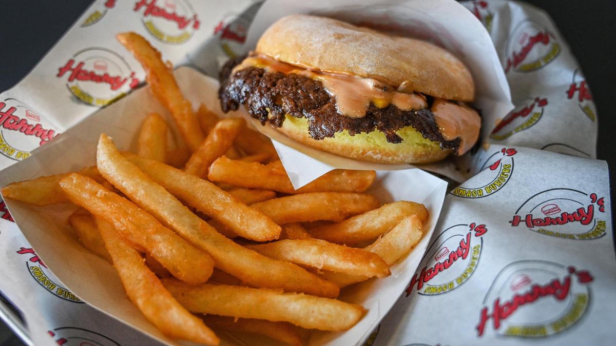 An original smash burger, prepared with grilled onions, cheese and special sauce, is plated with crispy fries at Hammy’s Smash Burgers on West Shaw Avenue in this file photo.