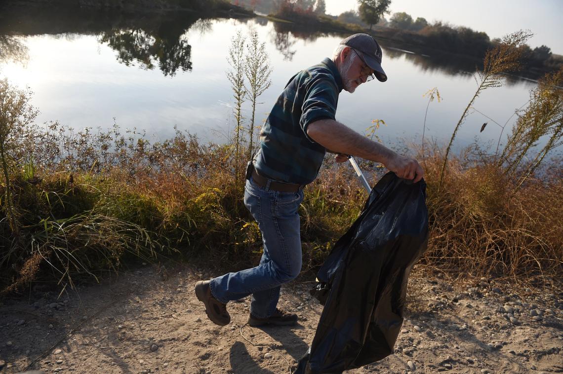 Tom Bohigian collects trash on the River West Open Space Area along the San Joaquin River Tuesday, Nov. 20, 2018. Bohigian started placing trash cans on the 508-acre property on the outskirts of Fresno a year ago and collects the trash once a week.