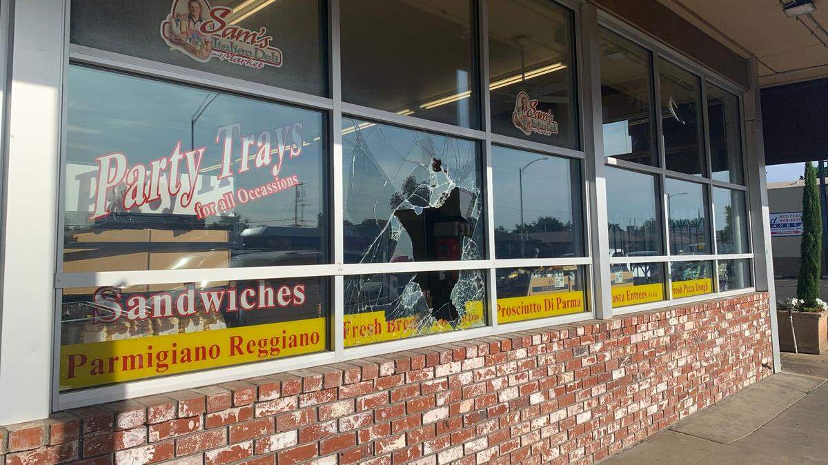 A broken window at Sam’s Italian Deli and Market where a burglary was reported June 8, 2022.