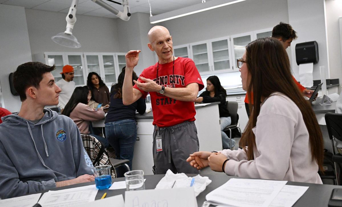 Dr. Mike Gilbert Ph.D. of the Math, Science and Eengineering Dept., center, leads instruction with students on the first day of instruction in the new Science Building at Fresno City College Monday, Jan. 13, 2025 in Fresno.