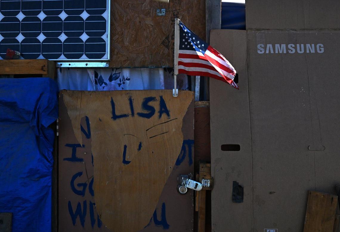 An American flag flies amid tents as we look inside the City of Tulare’s temporary encampment located at the south end of town Tuesday, Sept. 10, 2024.