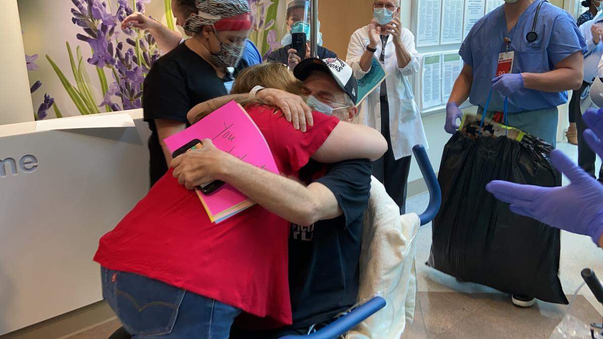 The Rev. Mark Wallace hugs his wife Tammy Wallace for the first time in a month after being discharged from Kaiser Permanente Fresno on May 7, 2020 after recovering from coronavirus.