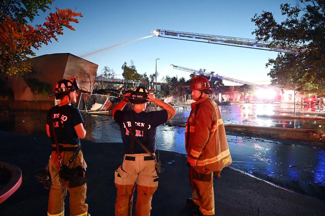 Fresno Fire crews responded to a fenced and boarded structure engulfed in flames at the 1200 block of E Street Friday evening, June 10, 2022 in Fresno. Fresno Battalion chief Dan O’Meara called the structure a complete loss.