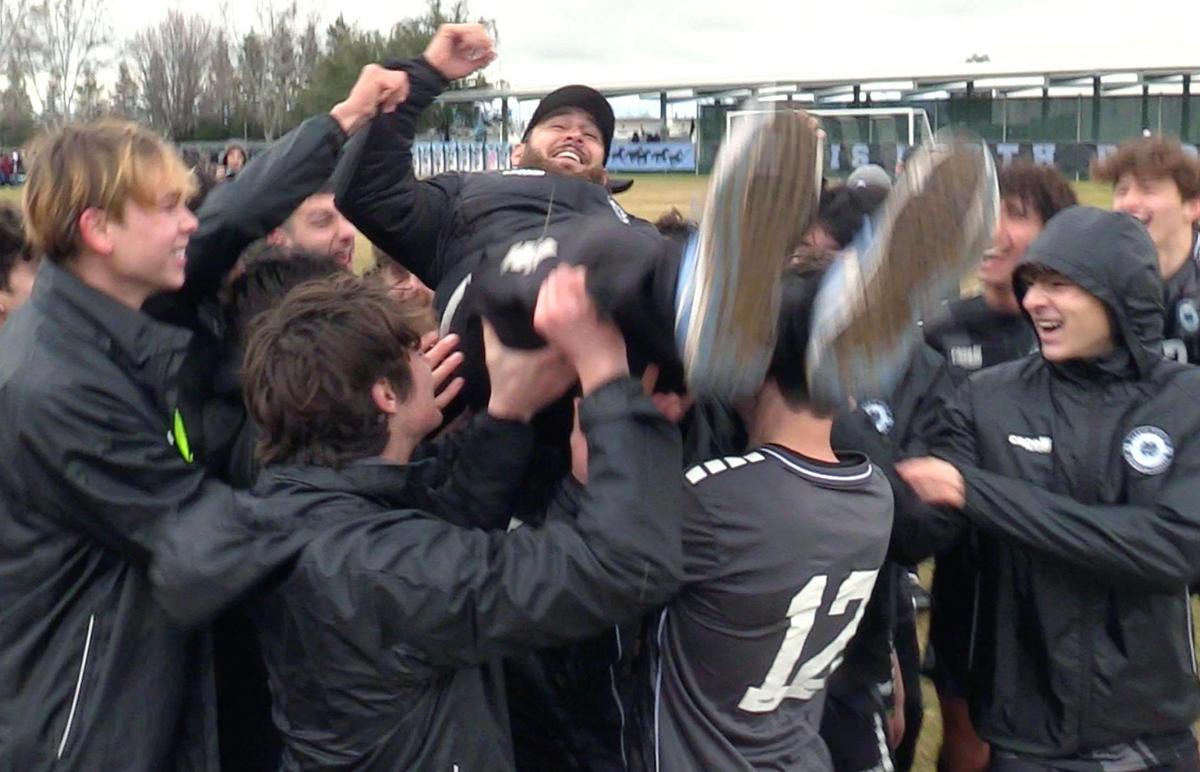 Clovis North players hoist coach Cameron Shahrokhi into the air as they celebrate a 3-1 win against Ridgeview in the Central Section Boys Division I soccer championship Saturday, Feb. 25, 2023 in Clovis.