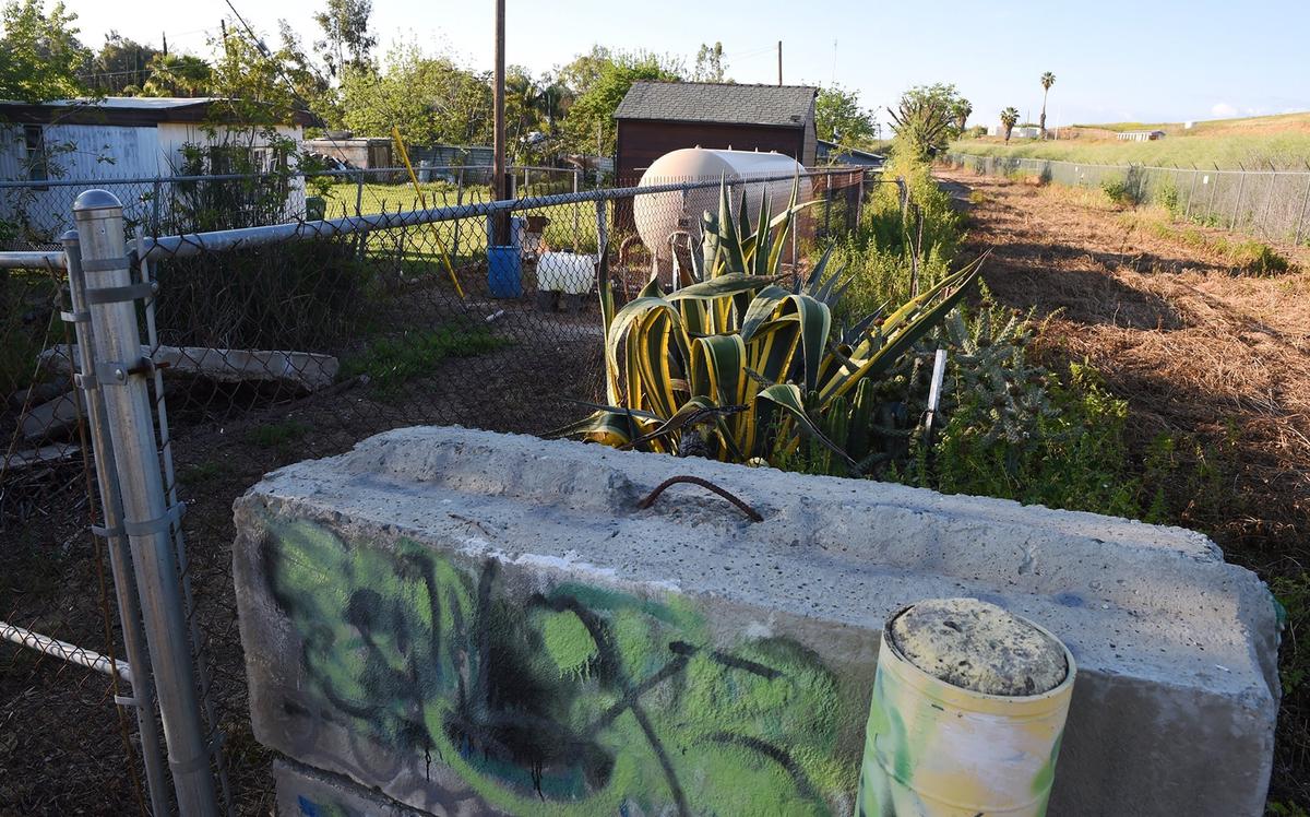 One of two water wells, background, is located behind fencing between a private home at the end of Morgan Road, a gravel road one block long, and a canal delivering water south. Photographed Friday, April 12, 2019 in Tooleville, CA.