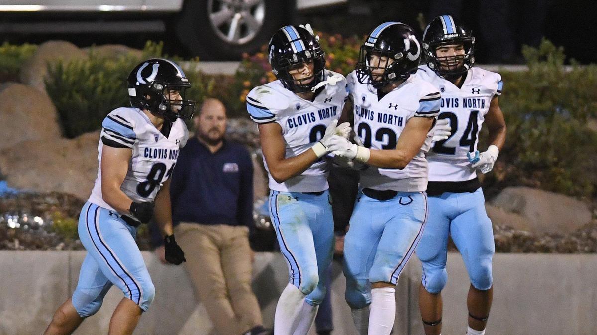 Players congratulate Clovis North’s Vincent Cordoba after scoring a touchdown against Clovis East during their TRAC opener at Lamonica Stadium on Friday, Sept. 29, 2023.