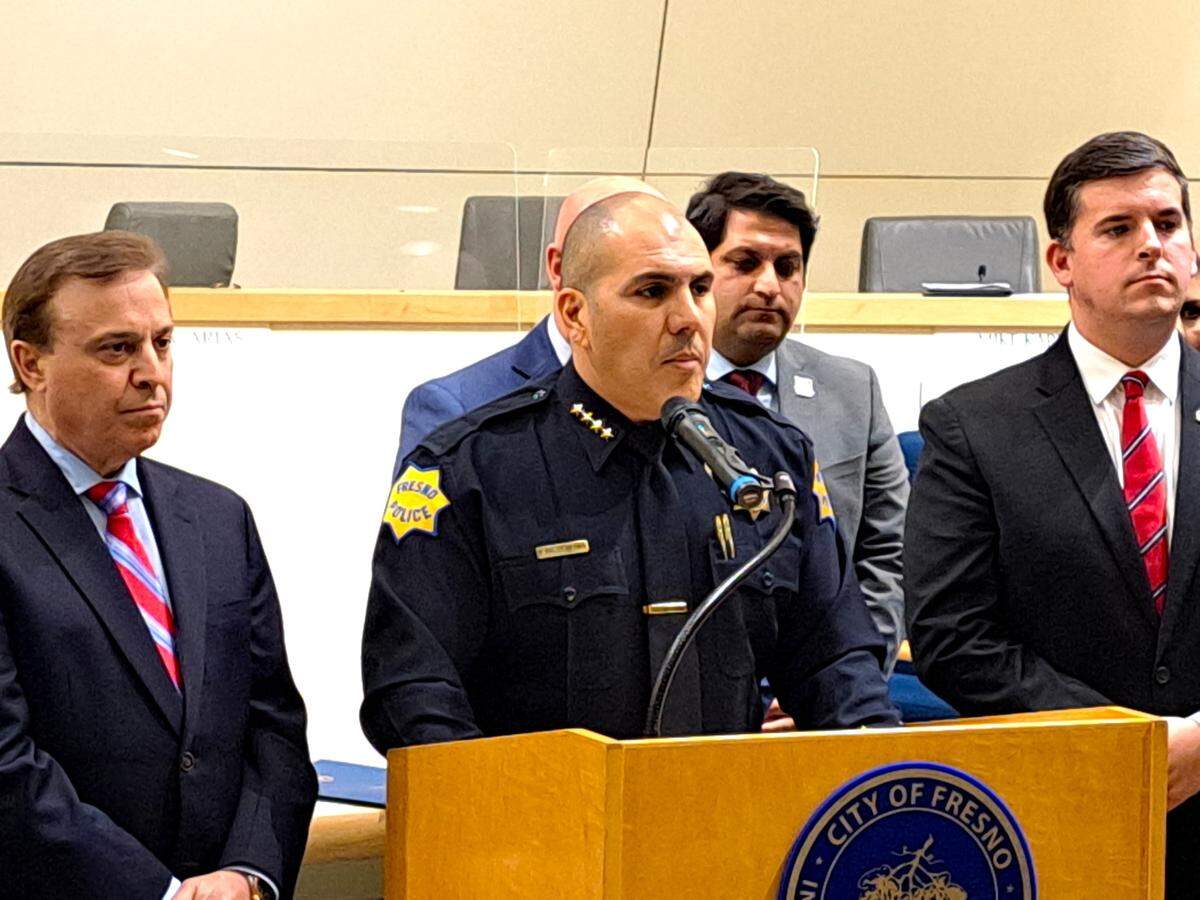 Fresno Police Chief Paco Balderrama, center, is flanked by City Councilmembers Garry Bredefeld, left, Mike Karbassi and Tyler Maxwell, right, as he addresses the city council’s unanimous vote on March 30, 2023, to increase pay for police dispatchers by 14%.