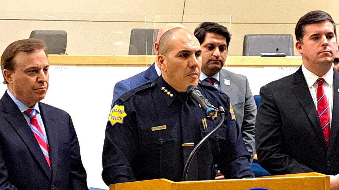 Fresno Police Chief Paco Balderrama, center, is flanked by City Councilmembers Garry Bredefeld, left, Mike Karbassi and Tyler Maxwell, right, as he addresses the city council’s unanimous vote on March 30, 2023, to increase pay for police dispatchers by 14%.