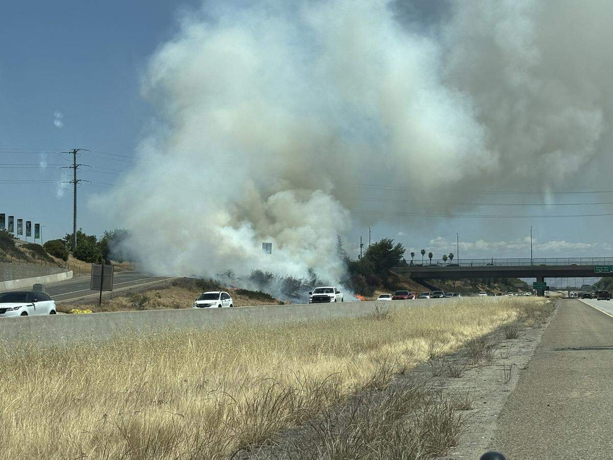 A grass fire at highway 99 near Jensen Avenue started Wednesday, May 14, 2025 in Fresno, California.