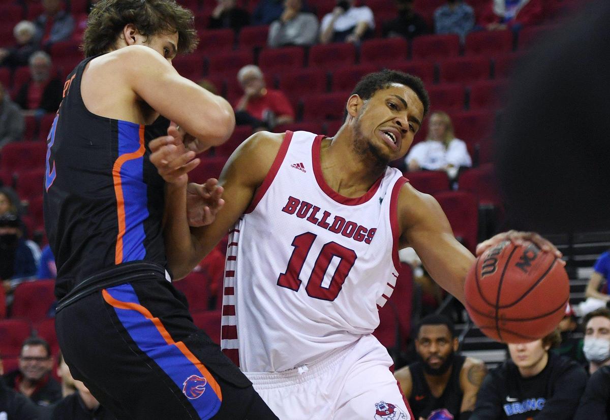 Fresno State forward Orlando Robinson, right, runs up against Boise State’s Tyson Degenhart in the Bulldogs’ 68-63 overtime loss to the Broncos, Friday, Jan. 28, 2022 in Fresno.