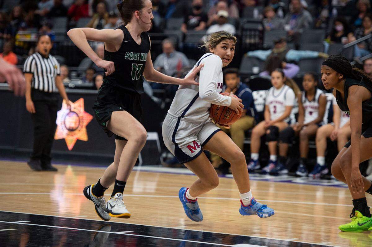 San Joaquin Memorial’s Asha Sra drives to the basket past Sage Hill’s Kat Righeimer during the CIF State Division II basketball championship on Saturday at Golden 1 Center in Sacramento.