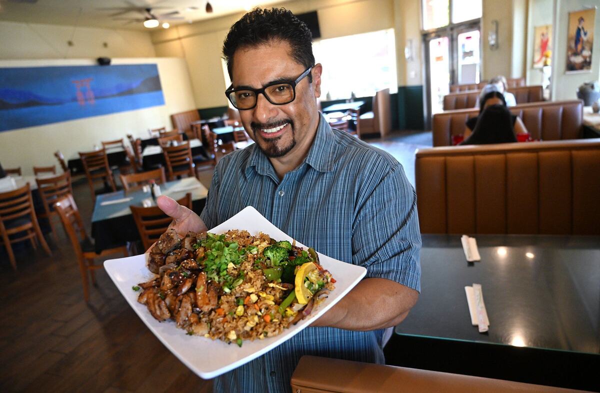 Jesse Mendoza holds a plate of Chicken and Steak Hibachi at his newly opened Oishi Sushi & Hibachi Thursday, Sept. 26, 2024 in Old Town Clovis.