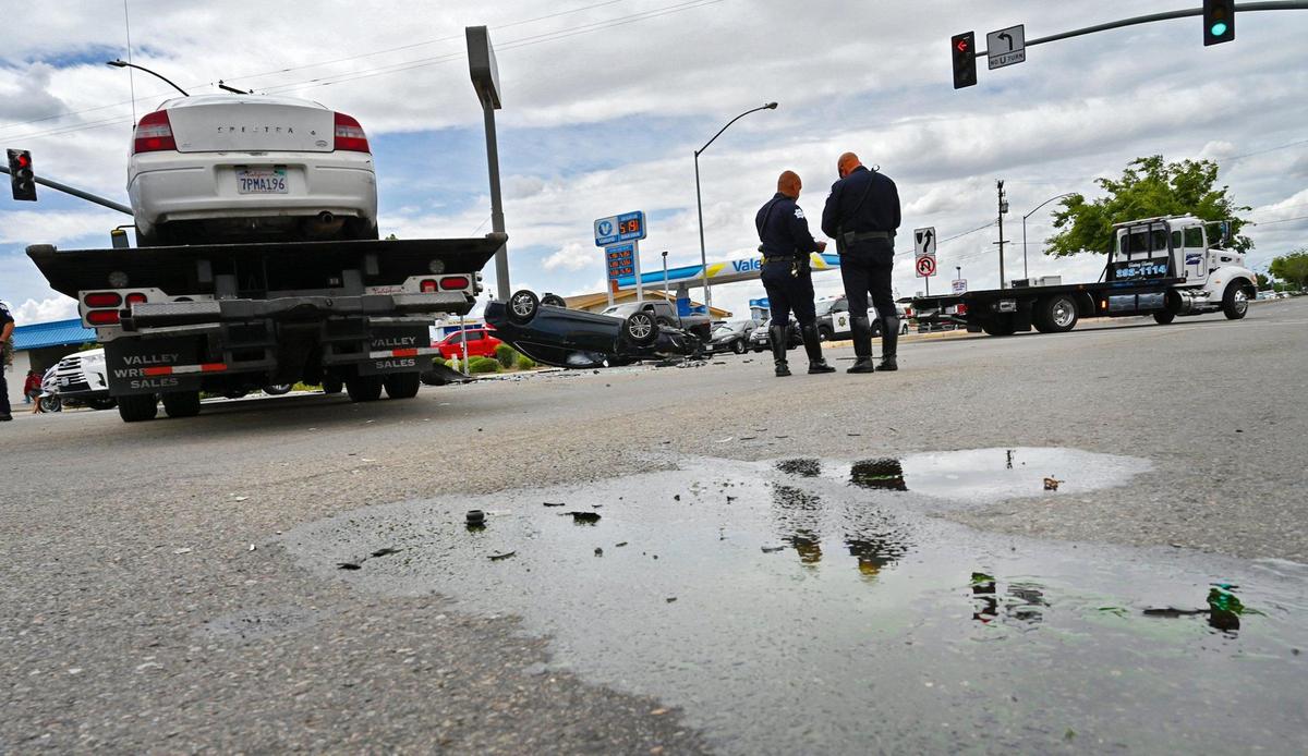 The scene of a three-vehicle collision including a rollover, photographed Tuesday, April 19, 2022 in Fresno. Fresno Police spokesman Felipe Uribe said a vehicle ran a red light and collided with two other vehicles, with one ended up on its roof.