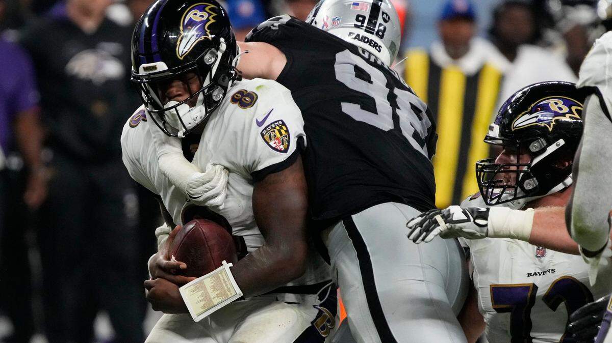 Las Vegas Raiders defensive end Maxx Crosby (98) tackles Baltimore Ravens quarterback Lamar Jackson (8) during the second half of an NFL football game, Monday, Sept. 13, 2021, in Las Vegas.