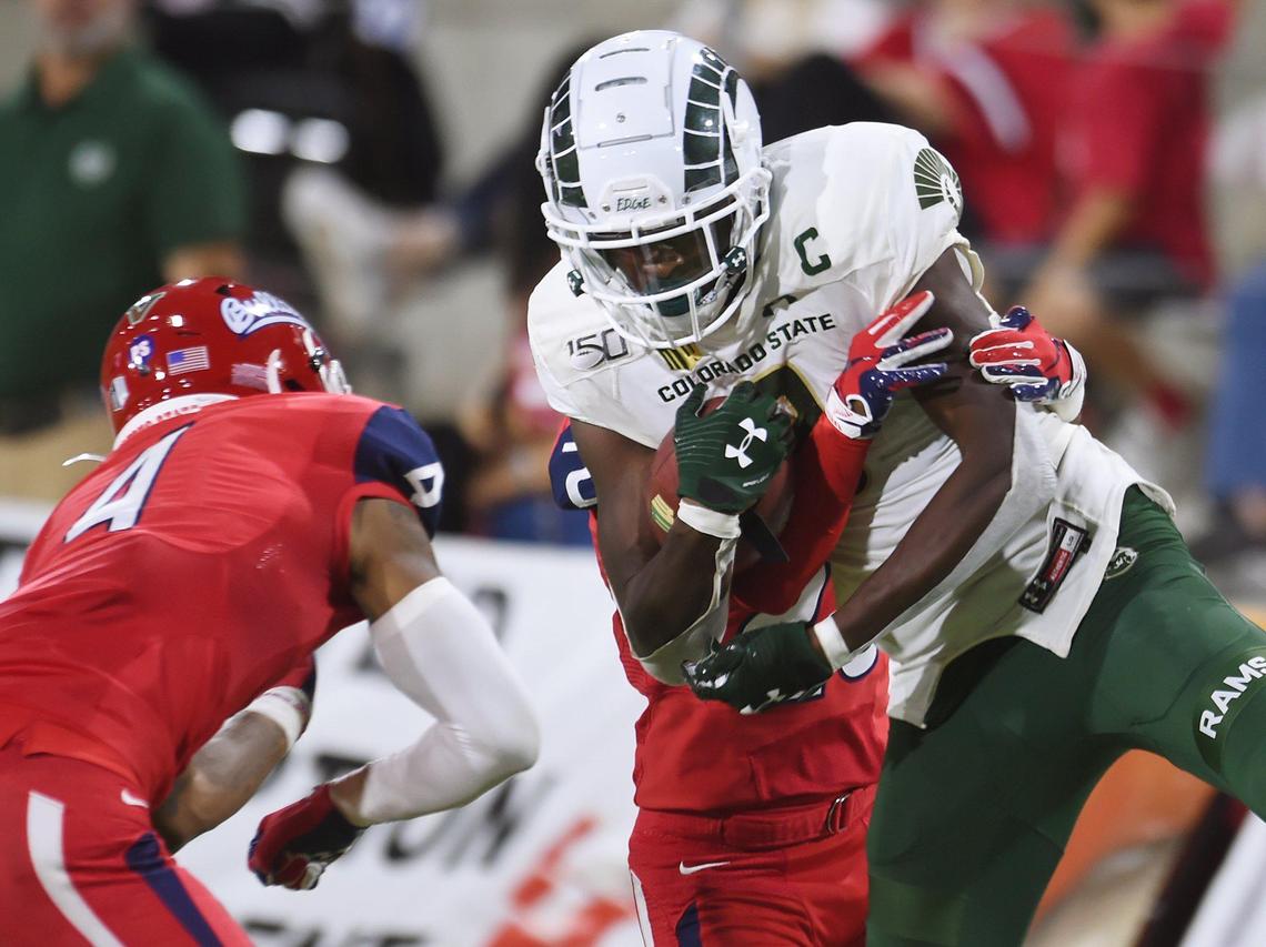 Colorado State’s Warren Jackson, right, makes the reception with Fresno State’s Wylan Free, left, and Mathew Sanchez, background, Saturday, Oct. 26, 2019 in Fresno.