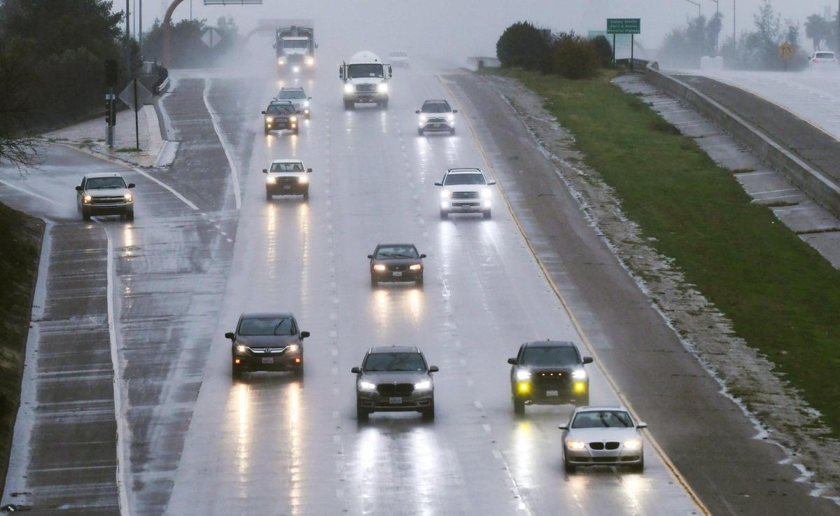 Southbound 41 traffic is seen natear the Herndon onramp, left, as an atmospheric river continues to dump rain Monday, Jan. 9, 2023 in Fresno.