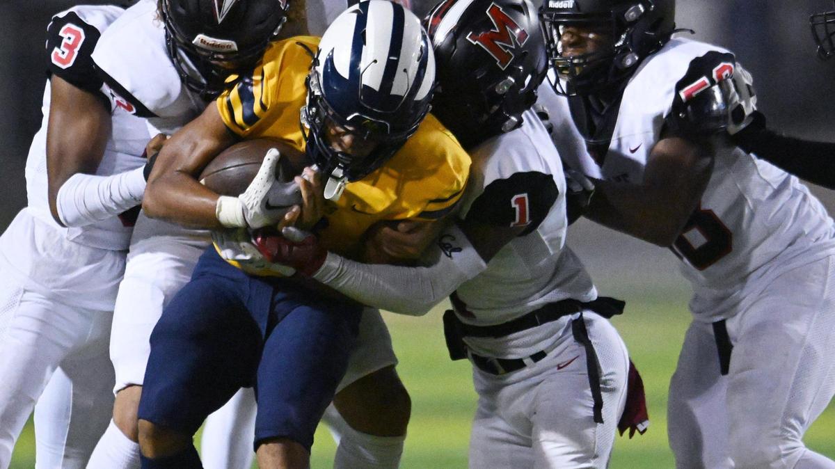 McLane’s defense swarms over Sunnyside’s Jason Dixon, center, Friday, Oct. 20, 2023 in Fresno.