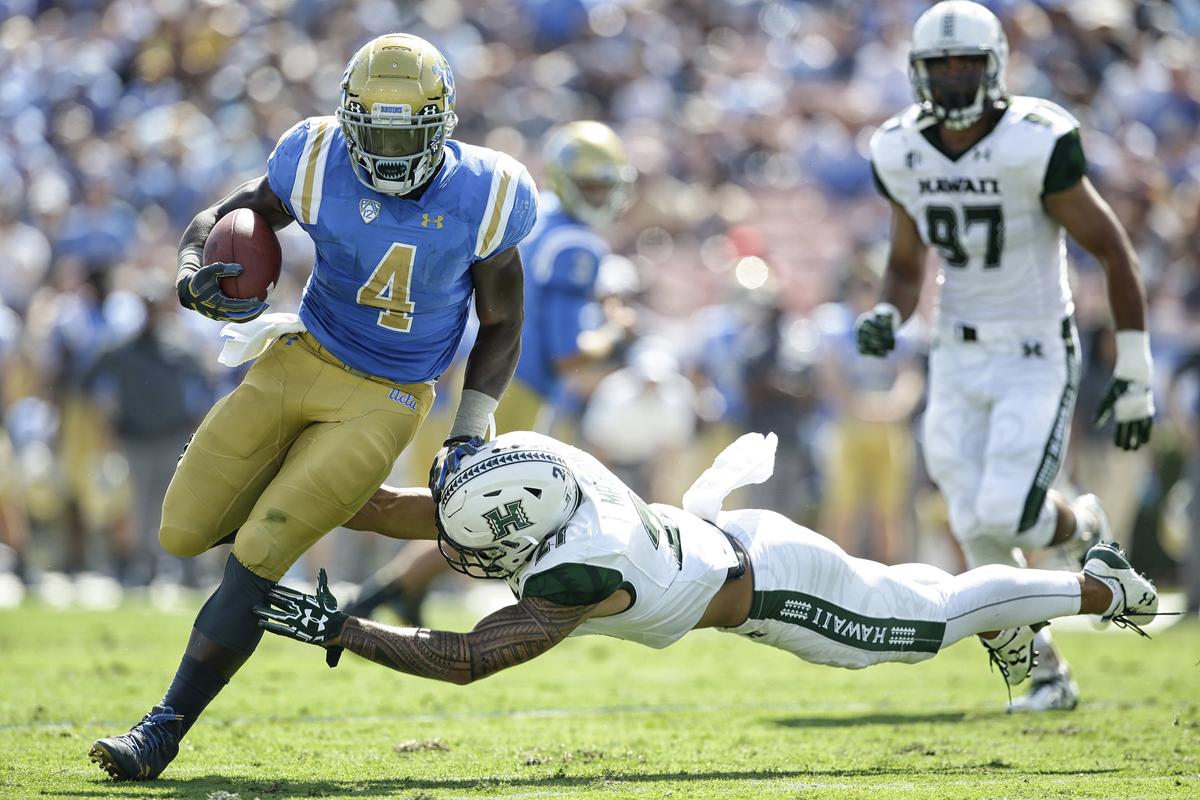 UCLA running back Bolu Olorunfunmi (4), a Clovis North grad, is leading the Bruins with 24 rushing attempts. He has gained only 69 yards, 2.9 per play, working behind an inexperienced offensive line.