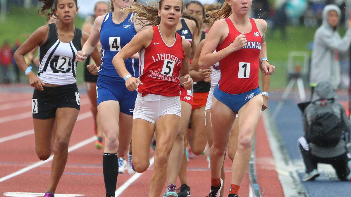 Buchanan’s Meagen Lowe, right, leads the pack en route to winning the 1,600 race at the Central Section Master Track and Field Championship at Veterans Memorial Stadium in Clovis, Calif., Saturday, May 18, 2019.