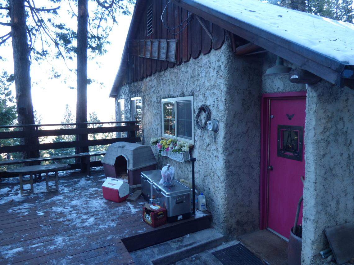 A photo shared by Erin Cook of her parents’ cabin in Alder Springs before it was destroyed by the Creek Fire. She said her mom thought of its pink door as the heart of their beloved home.