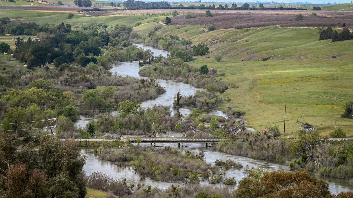 The San Joaquin River meanders past Friant as water is released from Friant Dam in excess of 8,000 cubic feet per second on Tuesday, April 11, 2023. Officials are expecting the massive Sierra Nevada snowpack will soon melt causing flooding issues downstream.