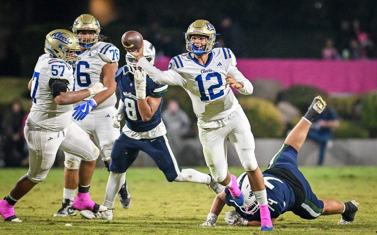 Clovis quarterback Deagan Rose pulls out of a potential sack while throwing to a receiver during their game against Clovis East at Lamonica Stadium in Clovis on Friday, Oct. 17, 2025.