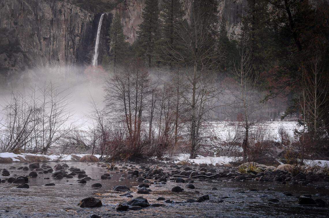 Light snow, ice and fog surround the area between Bridalveil Fall and the Merced River in Yosemite Valley after snow dusted the area over a few days, on Monday, Dec. 9, 2019.