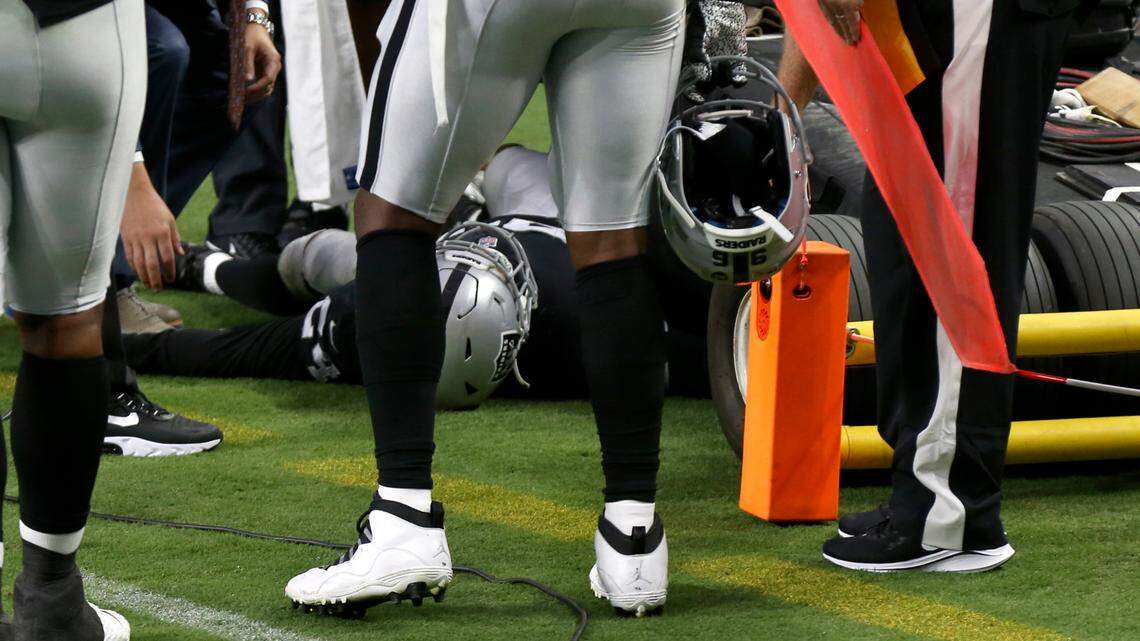 Las Vegas Raiders safety Johnathan Abram lies on the ground after hitting a TV camera cart during the first half against the New Orleans Saints on Monday in Las Vegas.