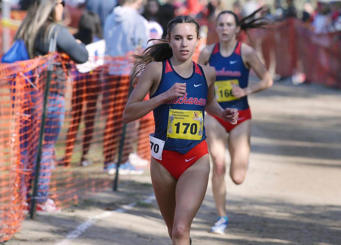 Buchanan’s Sydney Sundgren, left, is followed by teammate Grace Hutchison as they run the Division I race at the CIF State Cross Country Championships on Saturday, Nov. 27, 2021, at Woodward Park in Fresno.