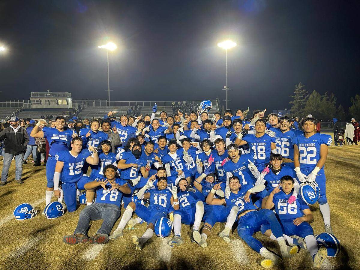 Caruthers pose for a photo after a dramatic win over Coalinga in the Central Section Division IV semifinal on Friday, Nov. 18, 2022.