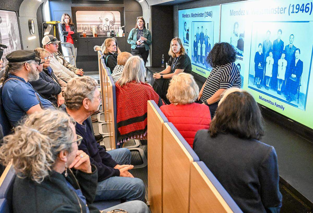Kelly Williams, center right, Director of Field Education West for the Mobile Museum of Tolerance holds a Civil Rights discussion aboard the Mobile Museum of Tolerance bus on an open house night at Bullard High School on Thursday, Feb. 12, 2026.