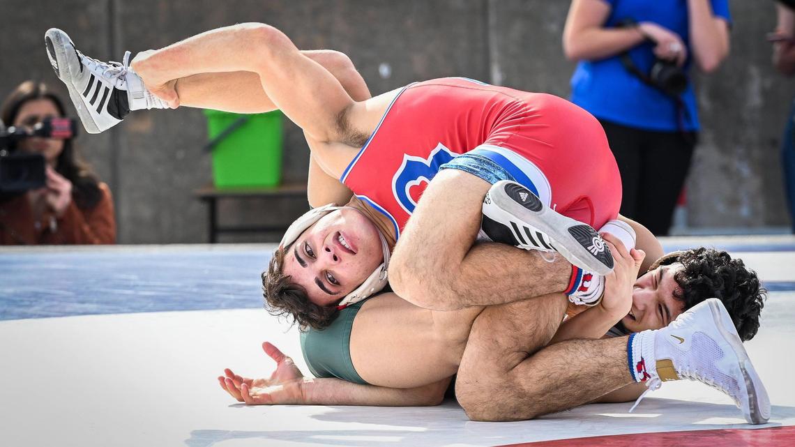 Buchanan’s Michael Gioffre, top, wrestles Johnny Lopez of Poway in the 140-pound match during their meet at Veterans Memorial Stadium on Saturday, Feb. 5, 2022.