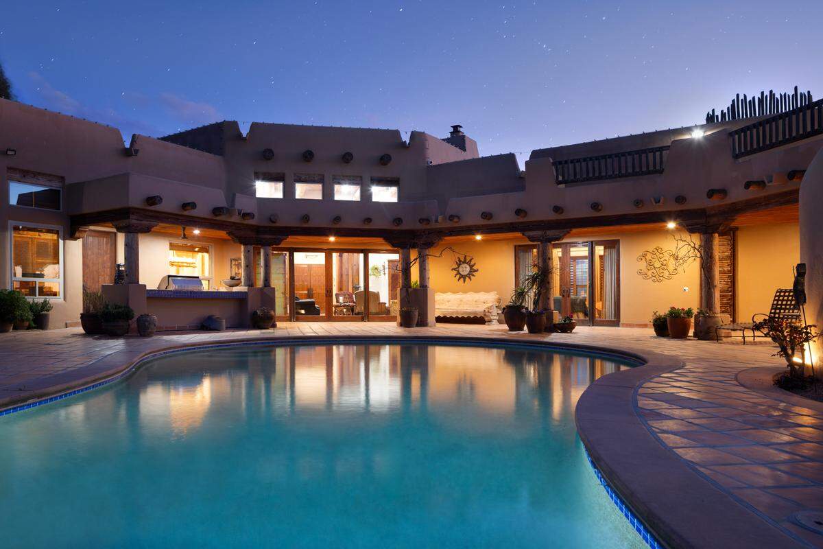 Amenities of the home in Friant, California, near Fresno include tennis, pickleball, basketball, an in-ground jacuzzi, outdoor fireplace, BBQ, putting green, observation deck and two independent guest homes.
