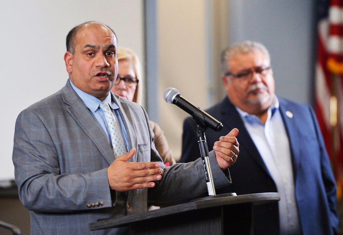 Dr. Rais Vohra, left, interim health officer for the Fresno County Department of Public Health, announces new coronavirus cases at a briefing for the media Friday afternoon, March 20, 2020 in Fresno.