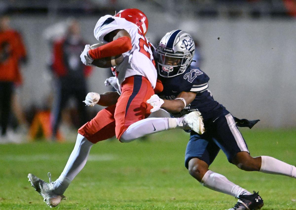 Clovis East’s Lindsey Graves, right, tackles Sanger’s Kayden McGrew, left, in a Central Section Division I quarterfinal game Thursday, Nov. 9, 2023 in Clovis.