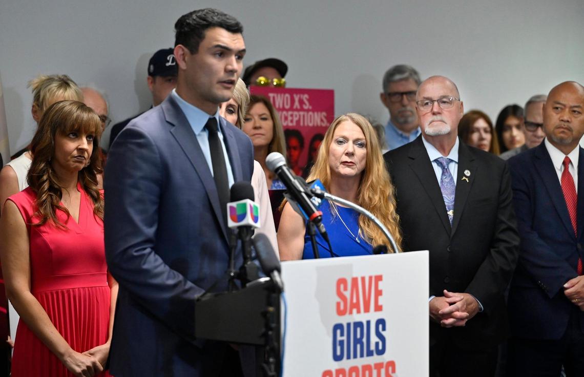 Clovis mayor pro tem Diane Pearse, far left, Clovis councilmember Drew Bessinger, second from far right and Clovis mayor Vong Mouanoutoua, far right, listen as Republican assemblyman David Tangipa speaks at a press conference pushing back against the inclusion of a transgender athlete at the CIF State Track & Field Championships Thursday, May 29, 2025 in Clovis. Clovis residents complained at a Clovis city council meeting about public resources used for the press conference and city funds being used for police overtime pay at the track meet.