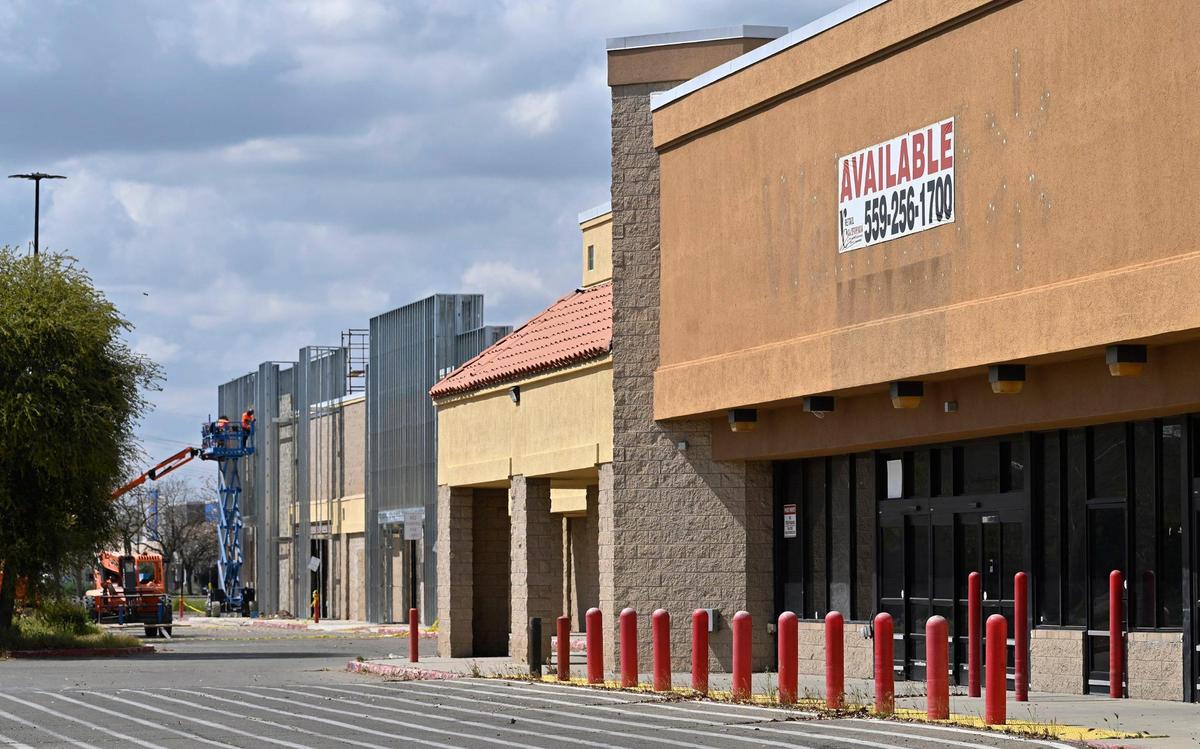 Two new businesses have signed leases for the former Walmart on West Shaw Avenue as construction workers work on the sprawling structure near Brawley Avenue.
