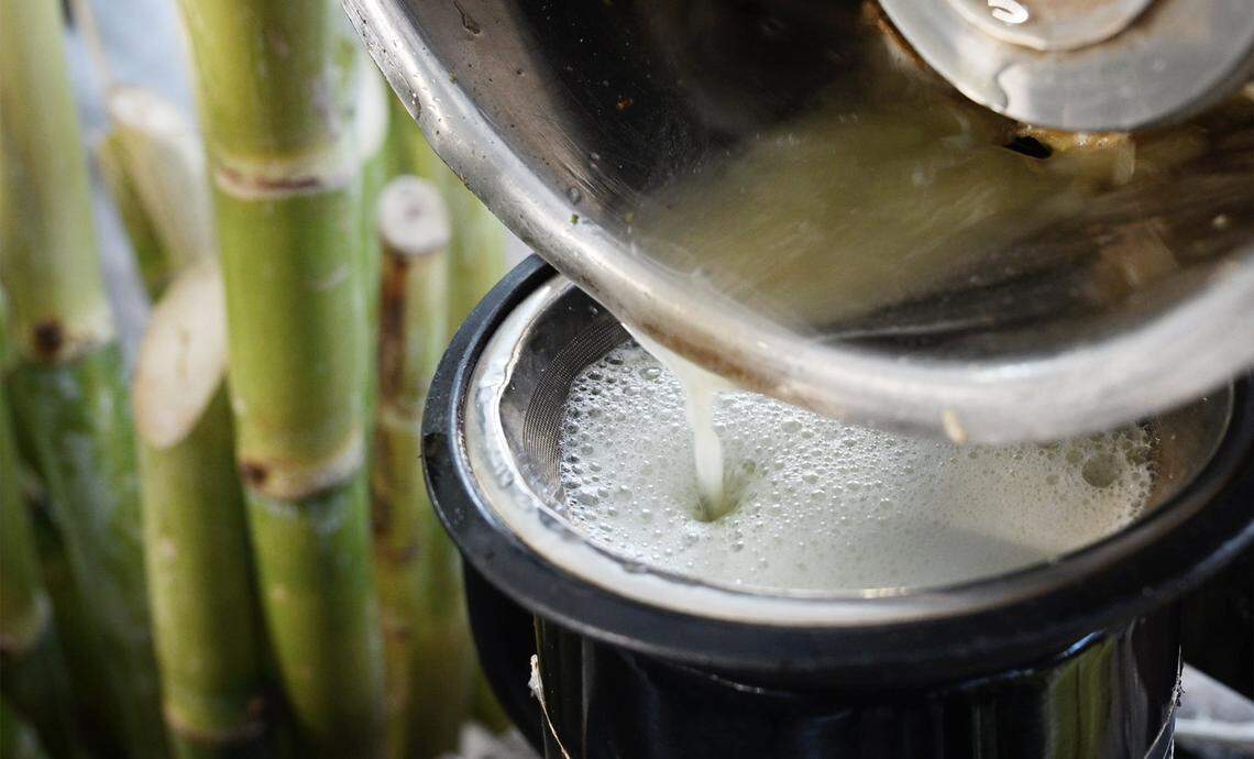 Juice is squeezed from sugarcane by a vendor at Lotus Pond and Night Market Friday night, Oct. 10, 2025 near Sanger.
