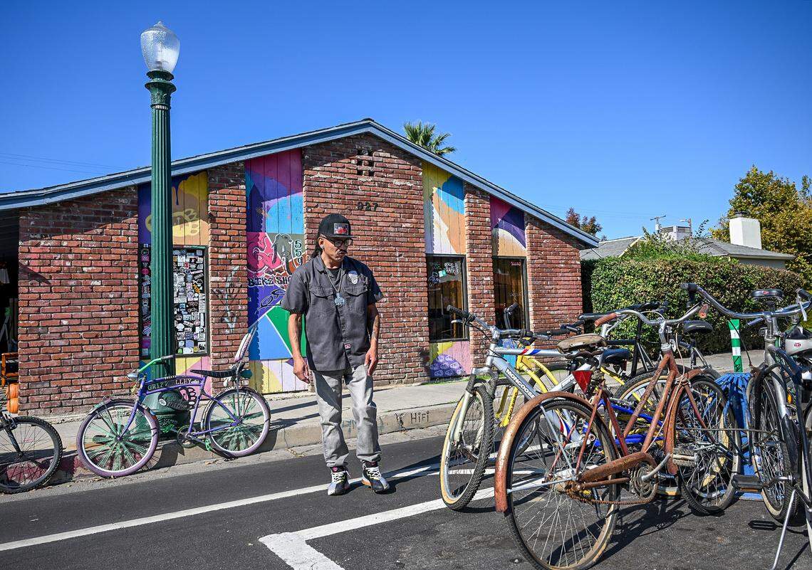 Luis Rodriguez looks over his bikes outside his Fresno bike shop, Grizzalley Bike Shope, on the southern edge of the Tower District.