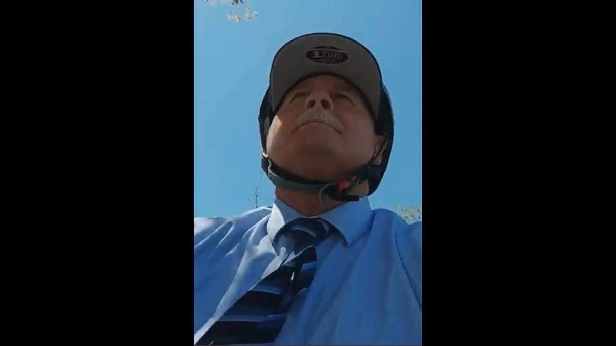 A closeup of Fresno Mayor Jerry Dyer, wearing a bike helmet, taken from a May 19, 2022, video posted on his official social media accounts.